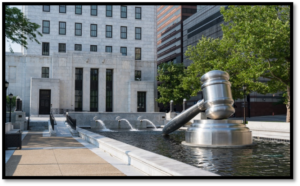 large statue of a gavel in a fountain in front of the Ohio Supreme Court building
