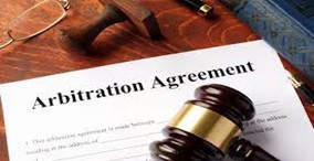 Document with the words "Arbitration Agreement" and a gavel sitting on top the document